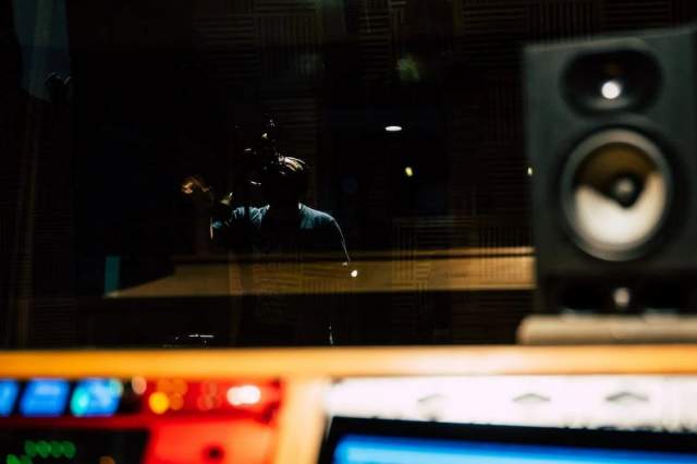 Voice over artist speaks in a recording studio.